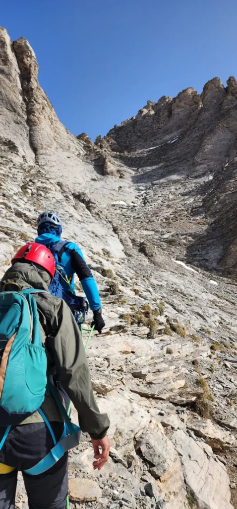 an olympus experience guide with a hiker heading to the summit Mytikas via Kakoskala
