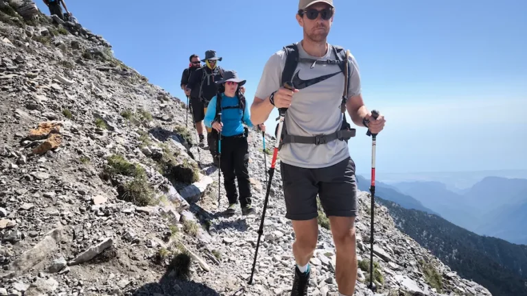 Hikers descending an alpine trail on Mount Olympus after completing the ascent