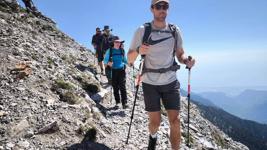 Hikers descending an alpine trail on Mount Olympus after completing the ascent