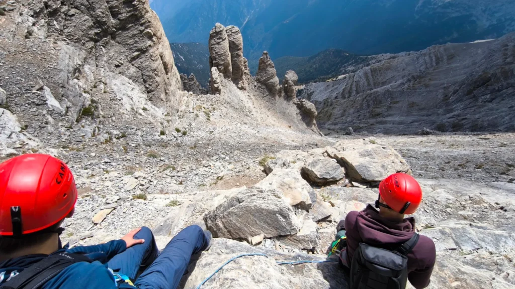 Candid moment of hikers resting briefly during a semi-guided ascent on Mount Olympus